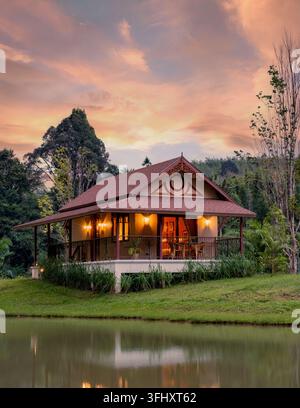 Charming countryside house at sunset in Khao Sok Thailand surrounded by nature Stock Photo