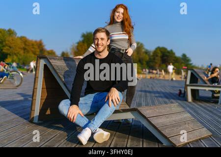 Young couple embracing on a chaise longue Stock Photo