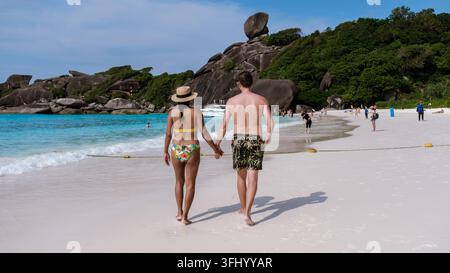 Couple enjoying a romantic walk on the pristine beaches of the Similan Islands in Thailand Stock Photo