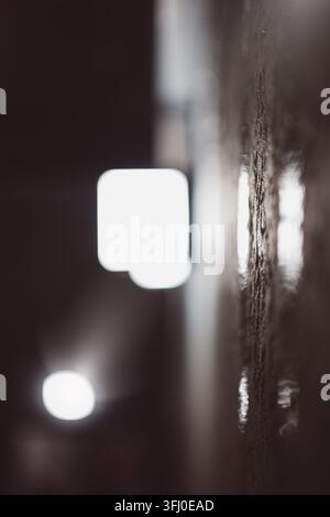 A macro, abstract, and artistic close-up photograph featuring a dark, rough, and textured vertical surface on the right side, contrasted with soft out Stock Photo