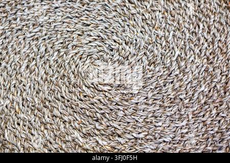 Eco friendly traditional braided fiber close up with circular weave ideal for handmade craft background ethnic country decor seamless wallpaper and ab Stock Photo