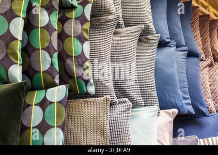 Variety of Patterned Cushion Pillows with Green Blue Stripes and Geometric Designs at Store Stock Photo