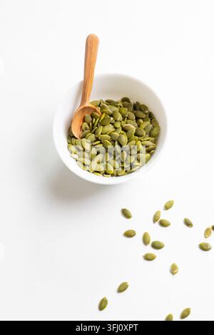 Pumpkin seeds in a white dish Stock Photo