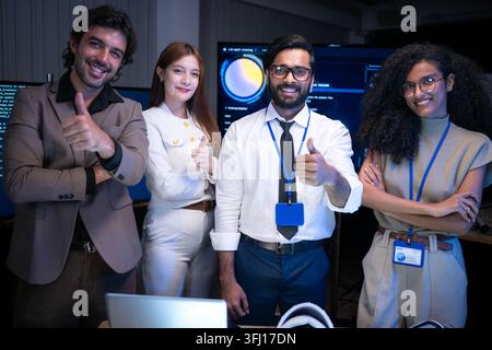 Portrait of confident multicultural technology and business team posing together in modern office environment with digital coding screens and innovati Stock Photo
