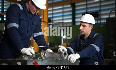 Industrial engineers and technicians discussing machine operation Stock Photo