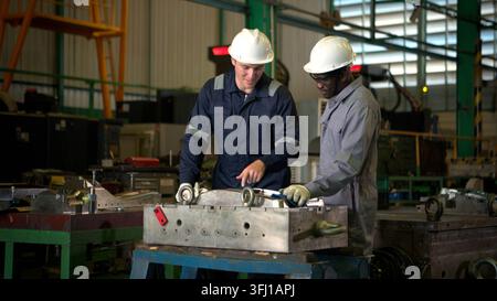 Industrial engineers and technicians discussing machine operation Stock Photo