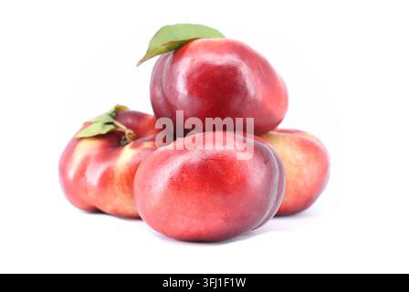 Flat nectarines, also known as rectangular nectarines, on white background. It's a variety of peach. Stock Photo