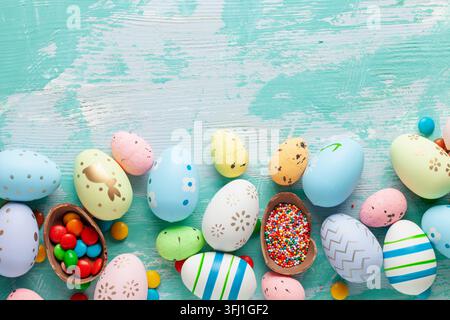 Colorful Easter Egg bottom border over a blue wooden background. Stock Photo