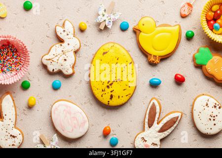 Glazed color gingerbread Easter figures - rabbit, chicken, egg, carrot   on bright background. Happy Easter. Top View Stock Photo