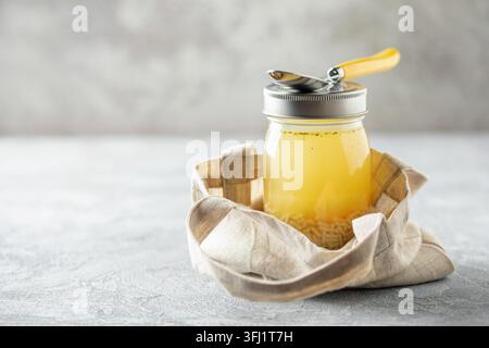 Chicken soup with  pasta in a glass jar on the table. Healthy office snack Stock Photo