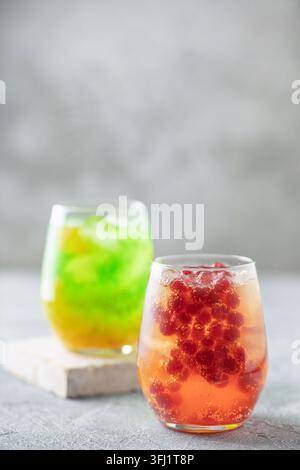 Glasses of homemade fruit lemonade with popping boba or bubble pearls. Trendy summer drink Stock Photo