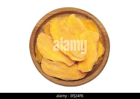 Slices of dried mango on wooden plate isolated on white background. Top view Stock Photo