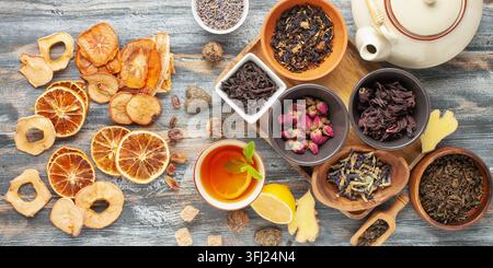 Set natural dried tea, fruits and teapot. Teatime. Tea ceremony concept. Top view. Flat lay. Stock Photo
