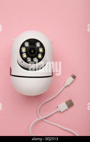 Security camera on pink background. Outdoor surveillance camera. Top view Stock Photo