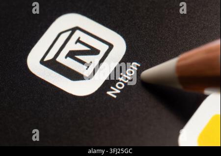 New York, USA - september 4, 2026: Press touch on Notion mobile application in pixel black background screen macro close up view Stock Photo