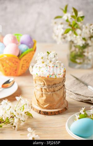 Easter orthodox sweet cakes, kulich, cherry blossom flower and colorful eggs . Holidays Easter concept. Stock Photo