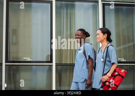 Diverse medical students walking happy on campus Stock Photo