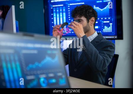 Business executive wearing smart glasses analyzing digital dashboards and business intelligence metrics in a modern office, demonstrating AI powered a Stock Photo