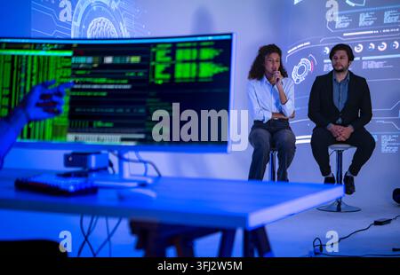 Technology professionals discussing AI software development with coding interface and global digital network visualization in a modern innovation work Stock Photo