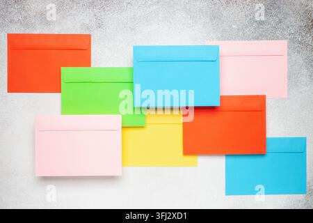 Multicolored envelopes on the table. Top view. Mock up concept Stock Photo