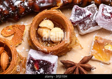 Traditional Turkish delight sweets with hazelnuts and star anise on festive background Stock Photo