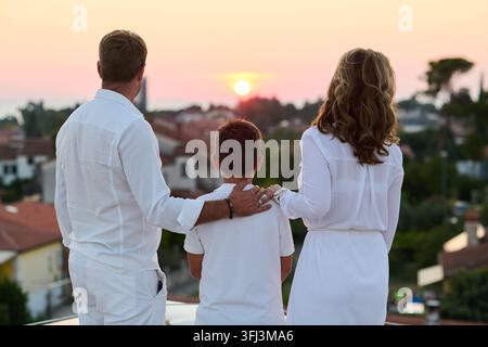 Family Watching Sunset From Rooftop Balcony With Sea View — Parents and Son Together Stock Photo