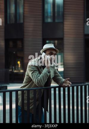 Young handsome Afro American man smiling and talking on cell phone on the street. Stock Photo