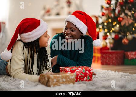 Mother and daughter celebrating Christmas with gifts Stock Photo