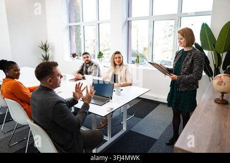Business colleagues collaborating during a project meeting in modern office Stock Photo