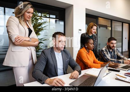 Business professionals collaborating at a modern office meeting Stock Photo