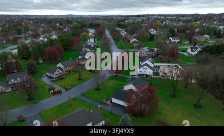 Upper Class Neighborhood in Suburb of USA during spring season. Rainy day with clouds at sky. Luxury large single Family houses in residential area. A Stock Photo