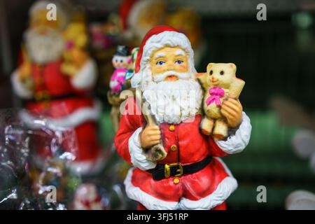 Christmas Santa Claus Ceramic Figurine with a Teddy Collectible Stock Photo