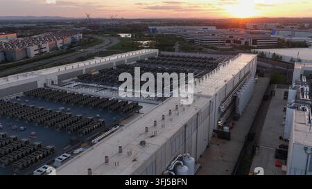 Large-scale data center complex in Ashburn, Sterling, Virginia at sunset with rooftop cooling systems, industrial infrastructure and high-tech cloud c Stock Photo