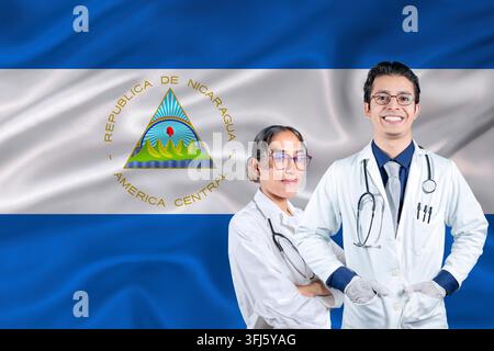 Team of doctors with Nicaragua flag in the background. Male and female doctors with Nicaraguan flag behind them. Nicaragua healthcare and medical care Stock Photo