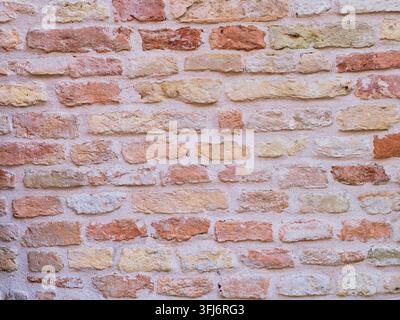 Wall made of different colored bricks Stock Photo
