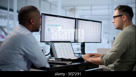 IT Consultants Collaborate Closely On ERP Software, Planning Business Solutions. Stock Photo