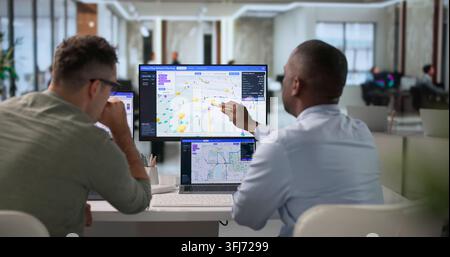 Network Engineer And Technician Review Fiber Optic Route Mapping Carefully. Stock Photo