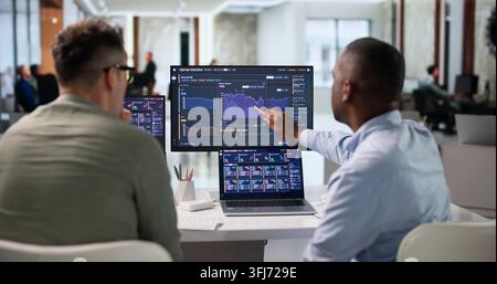 IT Specialist Carefully Monitors Server Performance Using Real-time Analytics Tools. Stock Photo