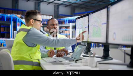 Logistics Coordinator Uses Laptop To Optimize Delivery Routes And Shipments. Stock Photo