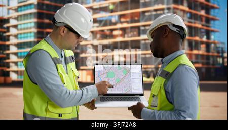 Civil Engineer And Contractor Review Site Plans Discussing Project Development Details. Stock Photo