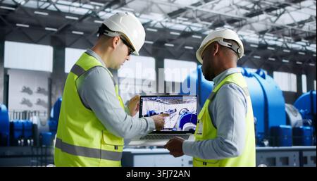 Engineer Closely Monitors 3D Simulation Of Power Plant’s Automation System. Stock Photo
