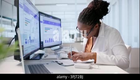 Healthcare Manager Carefully Reviews Medical Claims Using Laptop Software Dashboard. Stock Photo