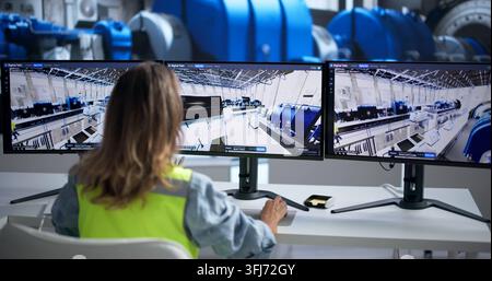 Engineer Uses 3D SCADA Software To Monitor Power Plant Systems Remotely. Stock Photo