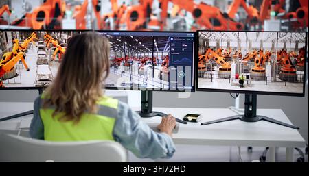 Engineer Uses Computer To Monitor Automotive Plant’s Real-time Production Line Data. Stock Photo