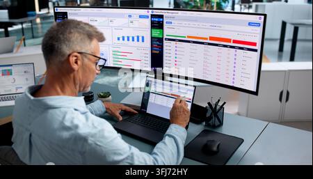 Healthcare Analyst Closely Reviewing Denial Management Dashboard On Laptop Computer. Stock Photo