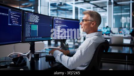 Software Developer Carefully Debugging Code In Cloud-based Programming Workspace. Stock Photo