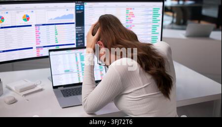 Young Business Analyst Feeling Headache While Coding Reports On Her Laptop. Stock Photo