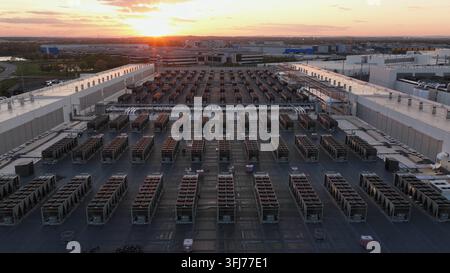 Aerial drone flyover of modern data center campus in Ashburn, Virginia, USA at sunset, showing rooftop cooling systems, technology infrastructure and Stock Photo