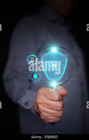 Hand holding magnifying glass focusing on glowing AI shield with lock icon and low risk indicators. Cybersecurity audit, data protection inspection, a Stock Photo