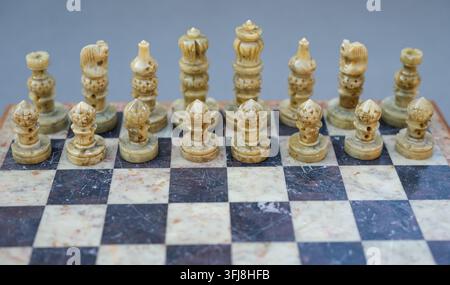White chess pieces on the board lined up for play. Shallow depth of field. Copy Space. Stock Photo